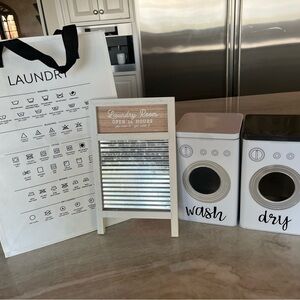 Laundry room decor including pod and dryer sheet canisters, sign decor and bag.